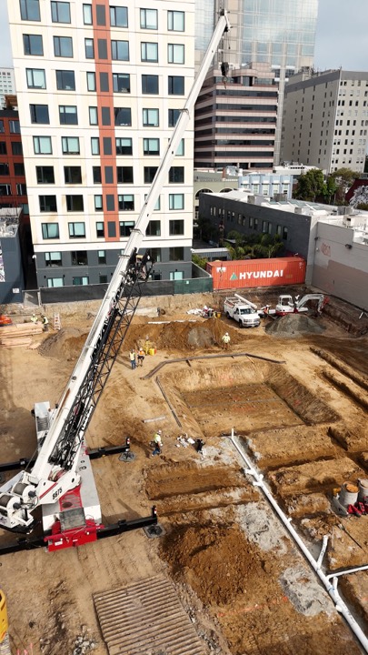Downtown excavation site with cranes, drone view