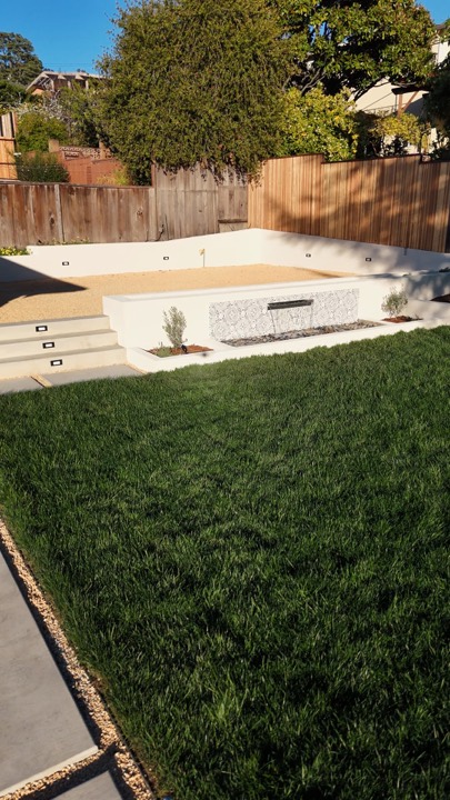 Finished backyard with new lawn, patio and seat wall